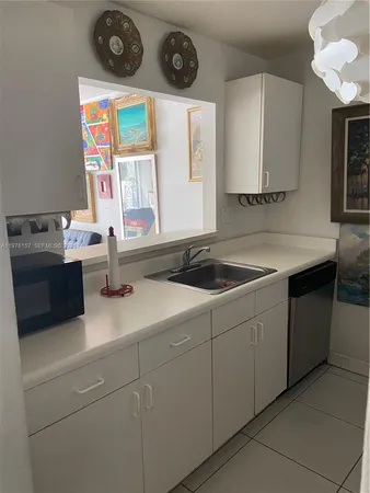 a kitchen with stainless steel appliances granite countertop a sink and a stove