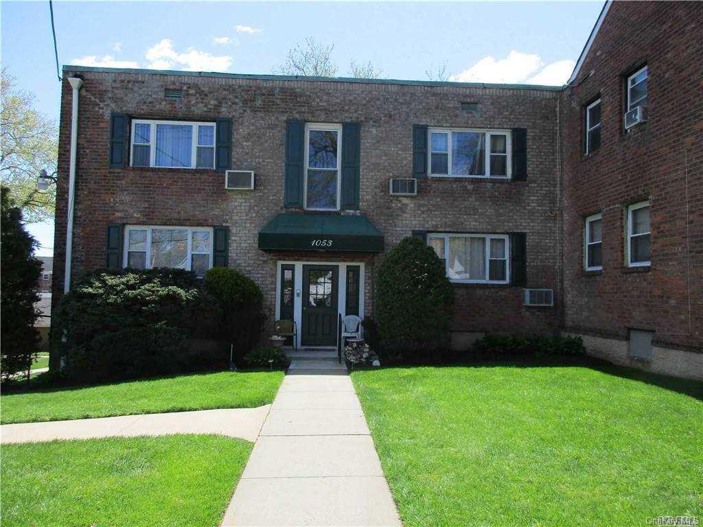 1053 Rottkamp Street, Unit 1 Valley Stream, NY 11580 - Photo 1 of 1 a front view of a house with a yard and garden