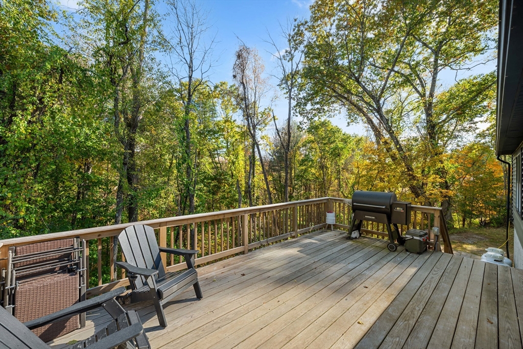 89 River Road Sturbridge, MA 01566 - Photo 26 of 31 a view of a balcony with wooden floor and bench