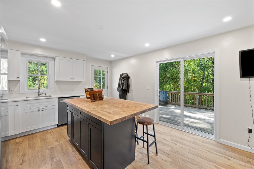 89 River Road Sturbridge, MA 01566 - Photo 6 of 31 a kitchen that has a sink a table and chairs in it