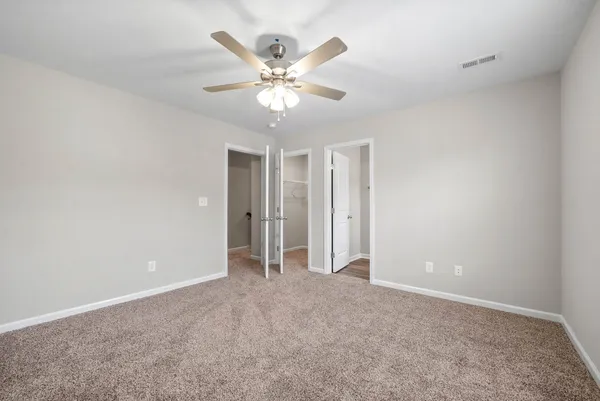 a view of an empty room with a fan