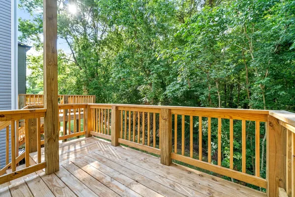 a balcony with wooden floor and outdoor space