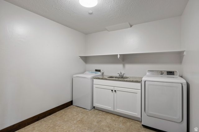 707 Chimney Rock Road, Unit 247 Heber City, UT 84032 - Photo 38 of 64 Washroom featuring a textured ceiling, washer hookup, and cabinet space