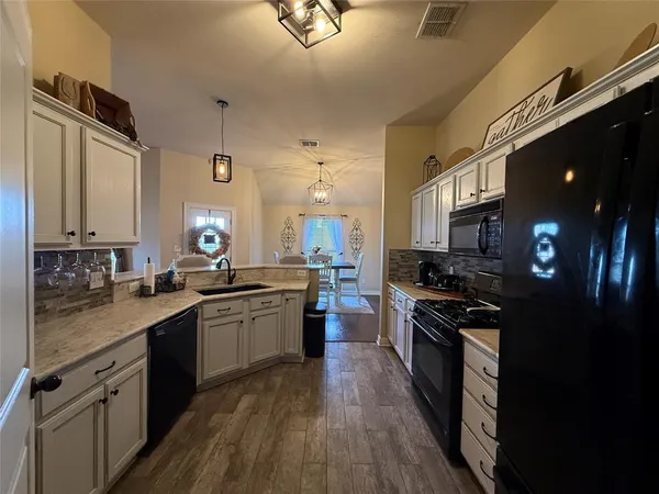 a kitchen with a sink stove and cabinets