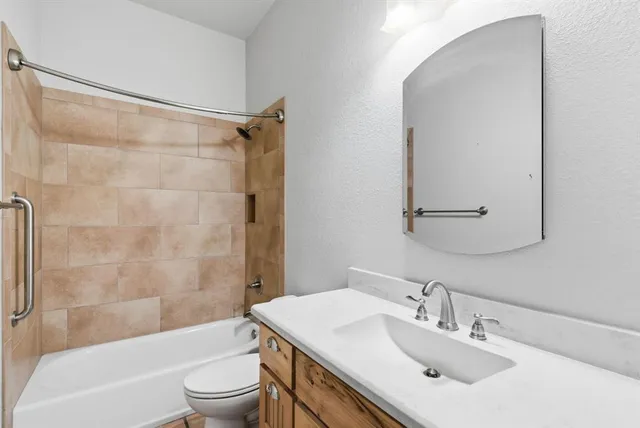 a bathroom with a sink mirror toilet and bathtub