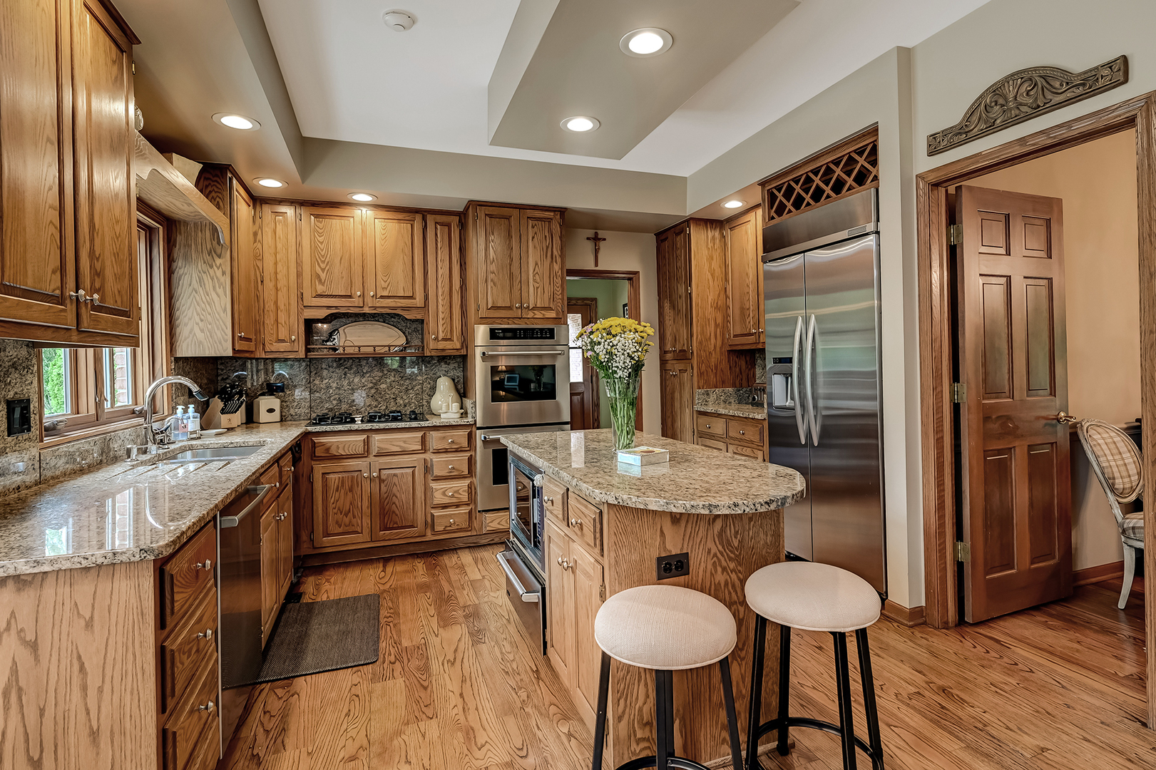 2 Hampton Court Burr Ridge, IL 60527 - Photo 11 of 38 a kitchen with stainless steel appliances granite countertop a sink refrigerator and cabinets