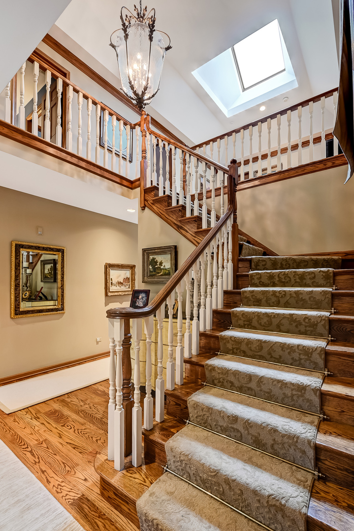 2 Hampton Court Burr Ridge, IL 60527 - Photo 18 of 38 a view of staircase with lots of frames on wall and a window