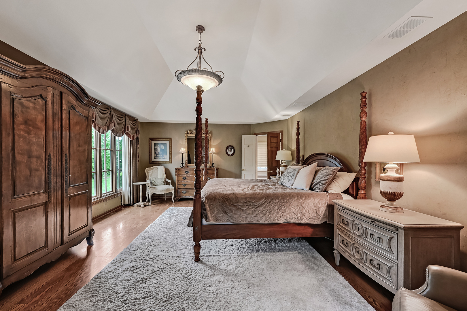 2 Hampton Court Burr Ridge, IL 60527 - Photo 20 of 38 a bedroom with bed and a chandelier