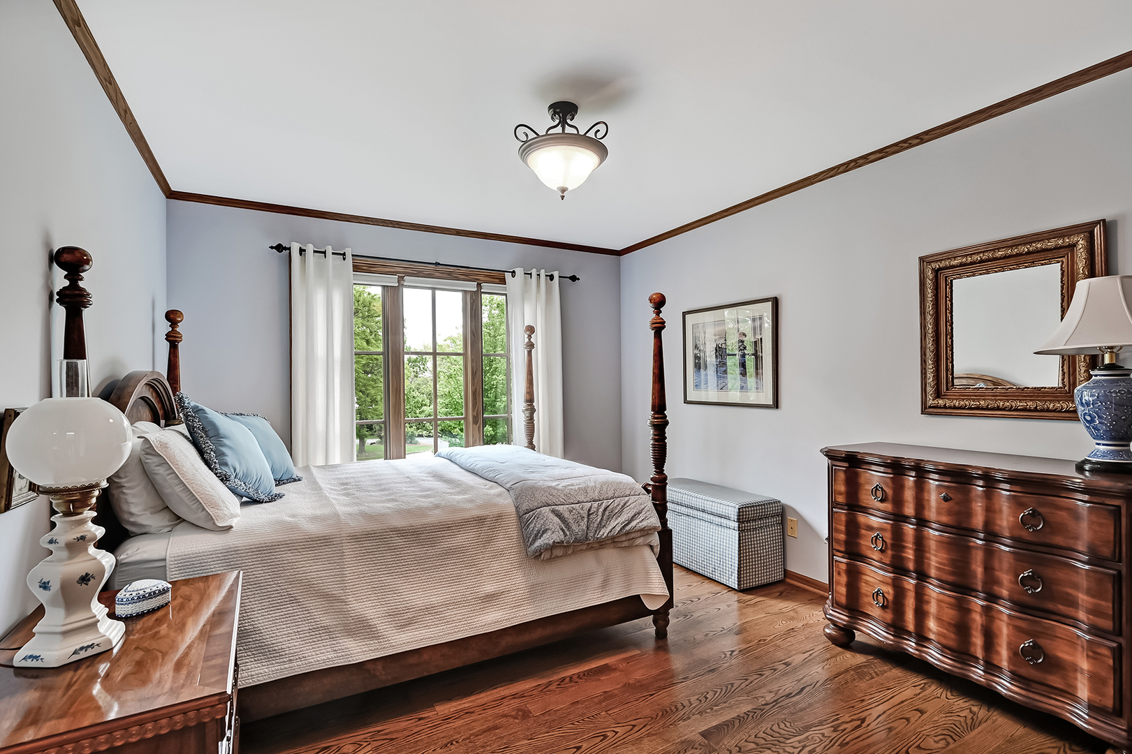 2 Hampton Court Burr Ridge, IL 60527 - Photo 23 of 38 a bedroom with a bed a dresser and wooden floor