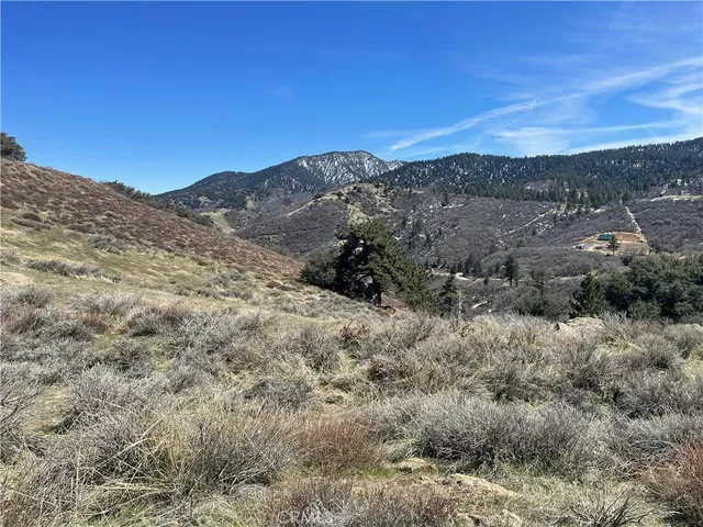 a view of a building with mountains in the background