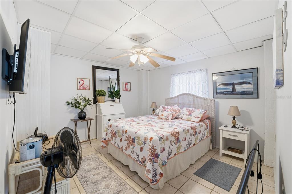 3366 Bluefish Drive Hernando Beach, FL 34607 - Photo 27 of 75 a bedroom with a bed a couch and potted plant on the dresser