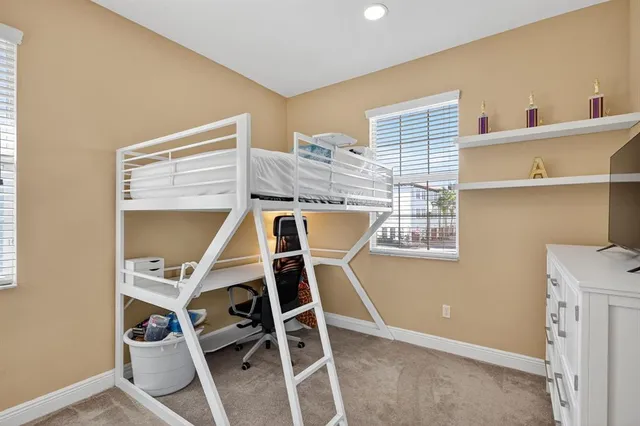 a view of a room with wooden floor and windows