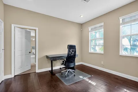 a workspace with wooden floor and a window