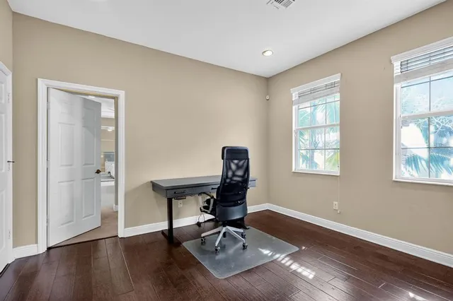 a workspace with wooden floor and a window