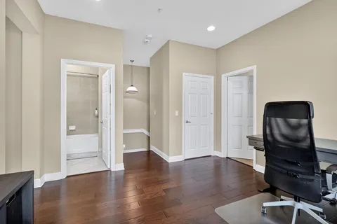a view of a workspace with wooden floor and bathroom