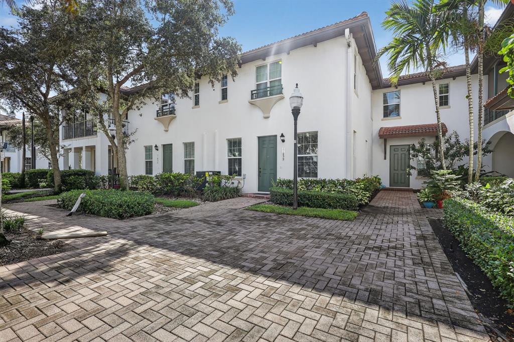 2669 Southwest 118 Road Miramar, FL 33025 - Photo 23 of 28 a view of a white house with large windows and plants