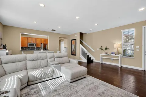 a living room with furniture and wooden floor