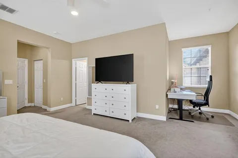 a bedroom with furniture and flat screen tv