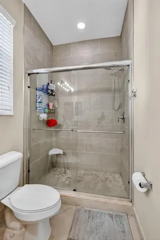 a bathroom with a shower and a toilet