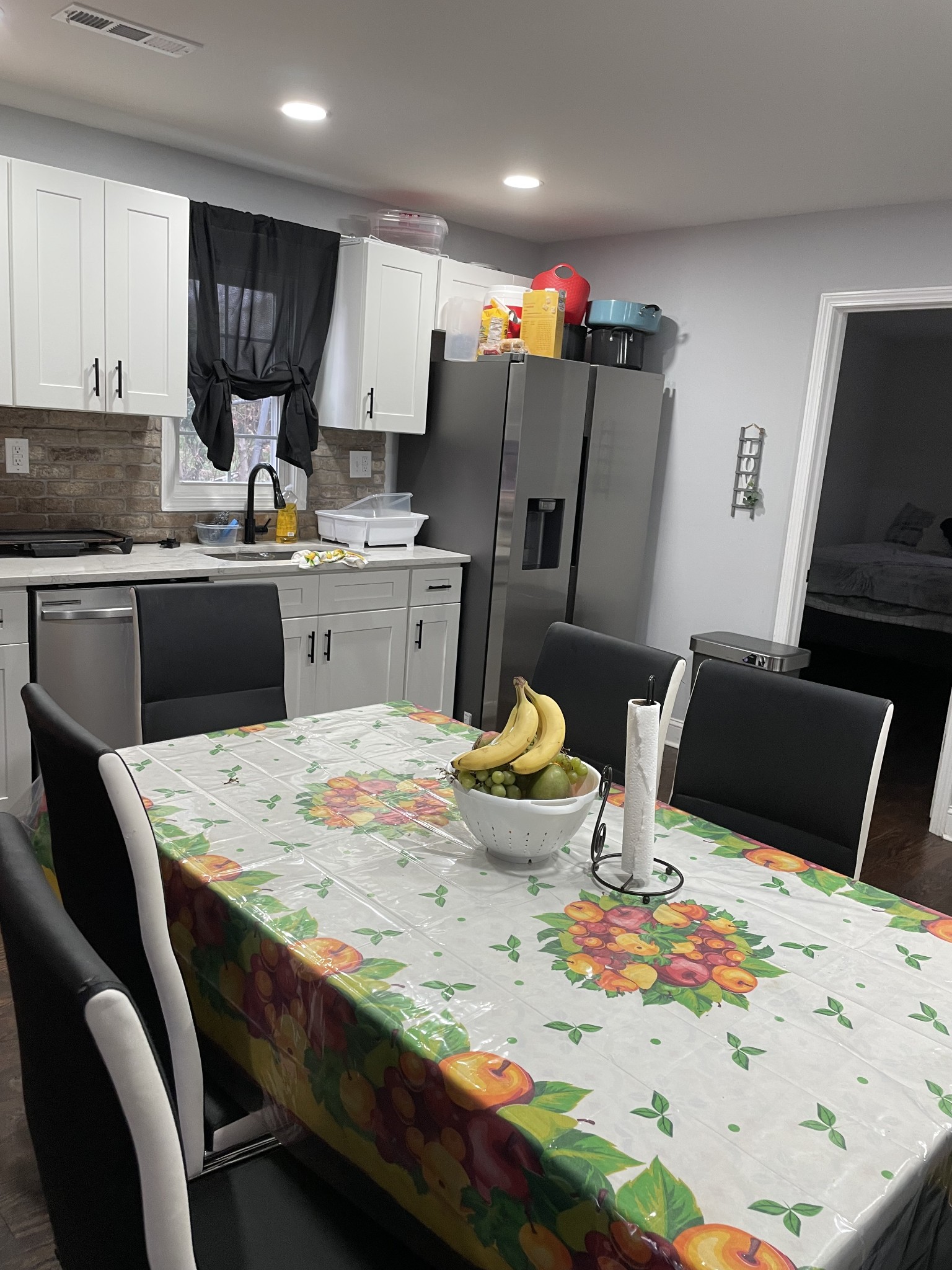 1161 Main Street Clarksville, TN 37040 - Photo 7 of 26 a kitchen with stainless steel appliances kitchen island granite countertop a table chairs and a refrigerator