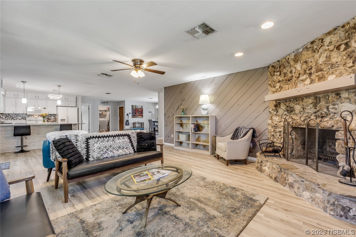 131 Silver Circle Edgewater, FL 32141 - Photo 15 of 30 a living room with furniture a fireplace and a chandelier