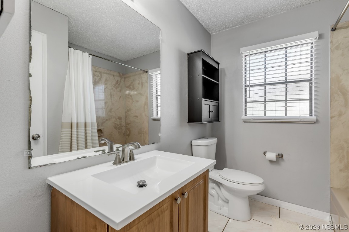 131 Silver Circle Edgewater, FL 32141 - Photo 17 of 30 a bathroom with a sink toilet and vanity