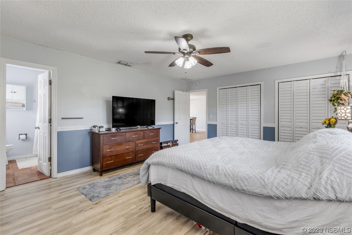 131 Silver Circle Edgewater, FL 32141 - Photo 20 of 30 a bedroom with a bed and a flat screen tv