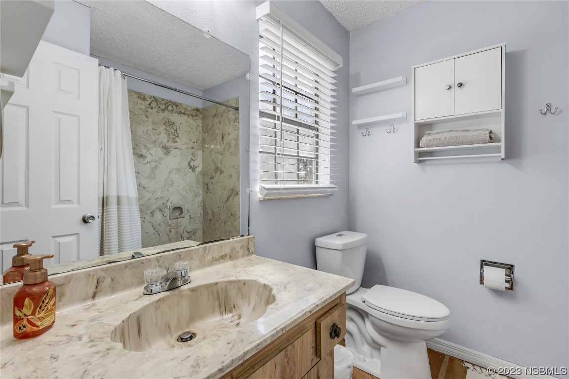 131 Silver Circle Edgewater, FL 32141 - Photo 21 of 30 a bathroom with a sink and a toilet