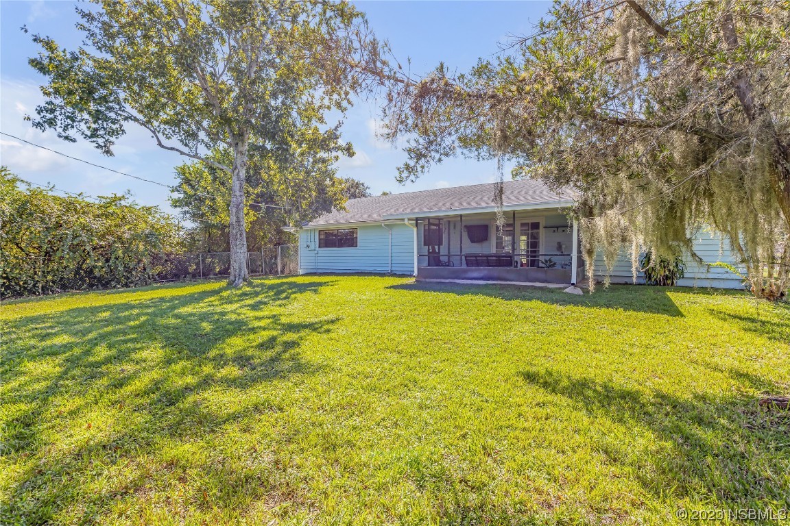 131 Silver Circle Edgewater, FL 32141 - Photo 25 of 30 a view of a house with a yard patio and tree