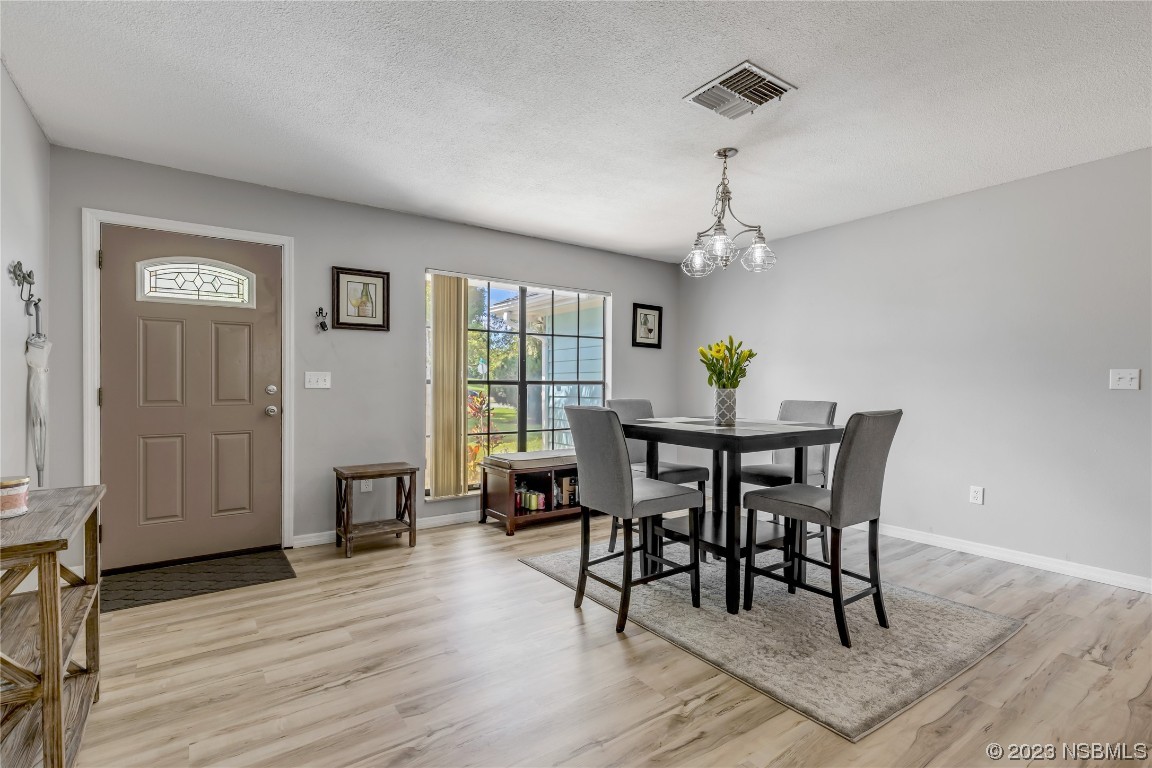 131 Silver Circle Edgewater, FL 32141 - Photo 4 of 30 a view of a dining room with furniture window and wooden floor