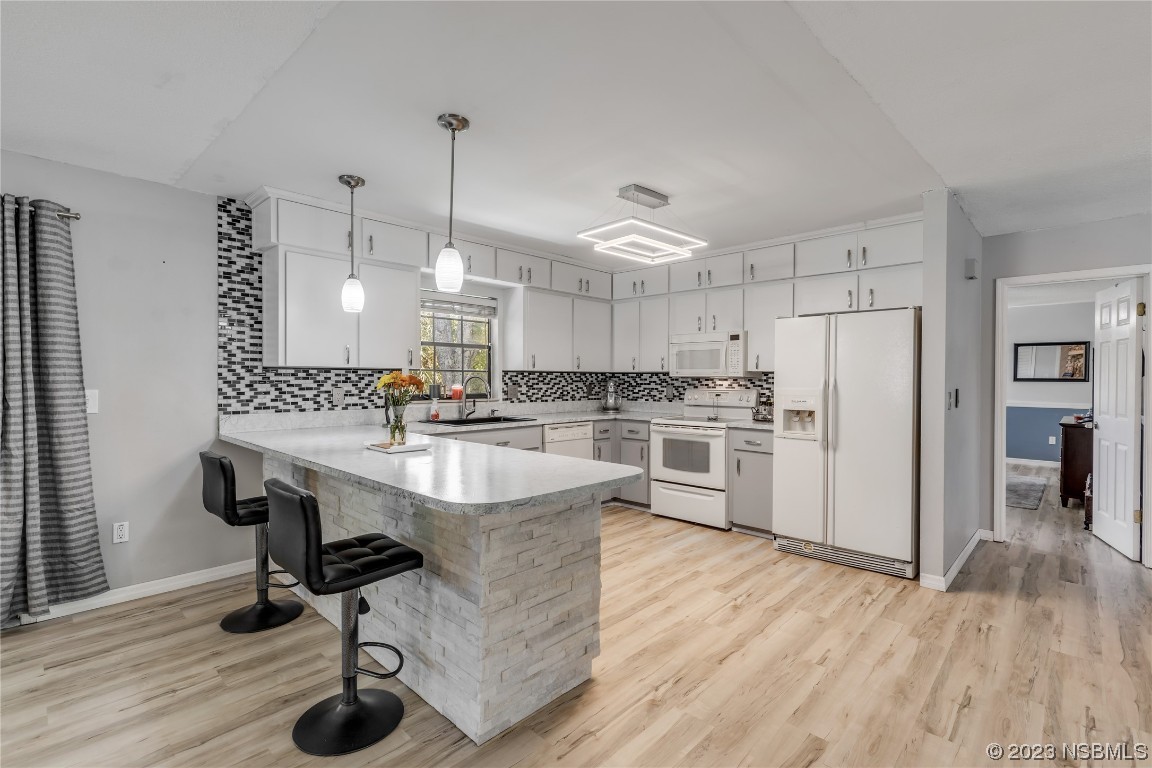 131 Silver Circle Edgewater, FL 32141 - Photo 7 of 30 a kitchen with kitchen island a white counter top space stainless steel appliances and wooden floor