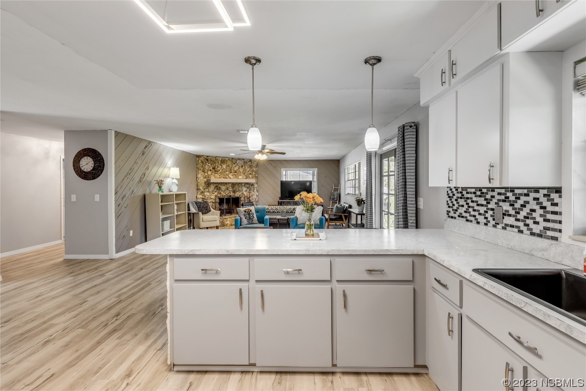 131 Silver Circle Edgewater, FL 32141 - Photo 10 of 30 a view of a kitchen with kitchen island a counter top space appliances and a ceiling fan
