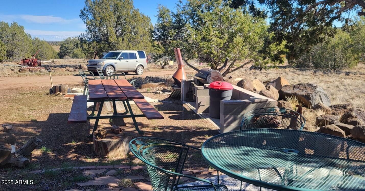 21750 North Ranch Road Williams, AZ 86046 - Photo 25 of 30 a view of a house with backyard water fountain and sitting area