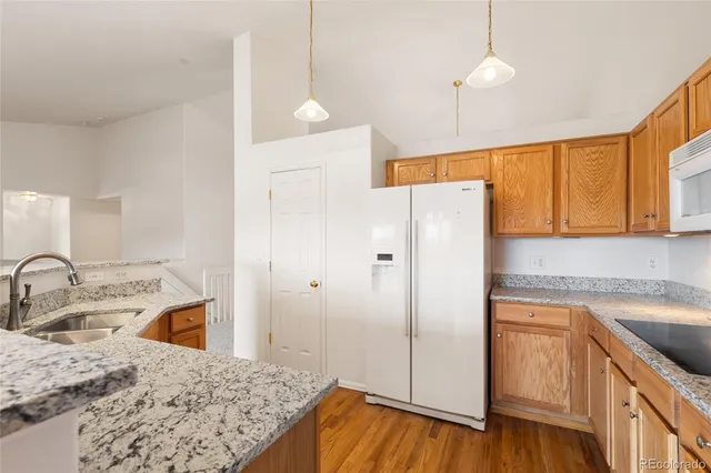 a kitchen with a refrigerator sink and white cabinets