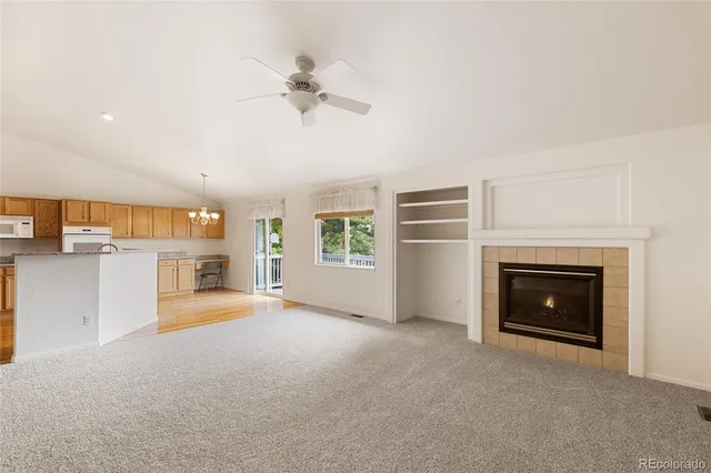 a view of a livingroom with an empty space and a fireplace