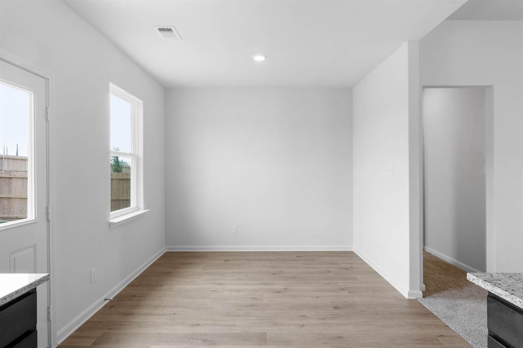 10137 Throttle Lane Fort Worth, TX 76131 - Photo 3 of 7 a view of an empty room with wooden floor and a window
