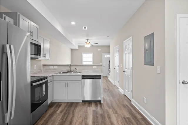a kitchen with stainless steel appliances a sink stove and refrigerator