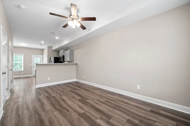 a view of a kitchen with a dishwasher and wooden floor