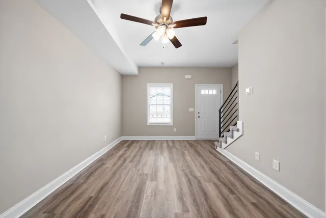 wooden floor in an empty room with a window