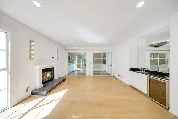 a view of an empty room with a fireplace and a window