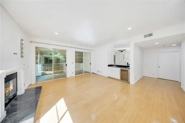 a large white kitchen with granite countertop a stove top oven a sink and dishwasher