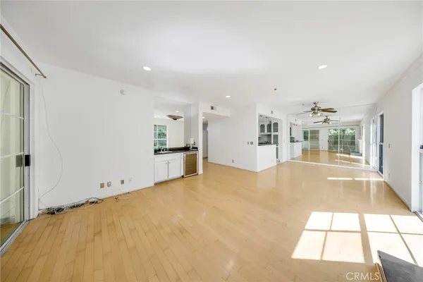 a view of an empty room with a fireplace and a window