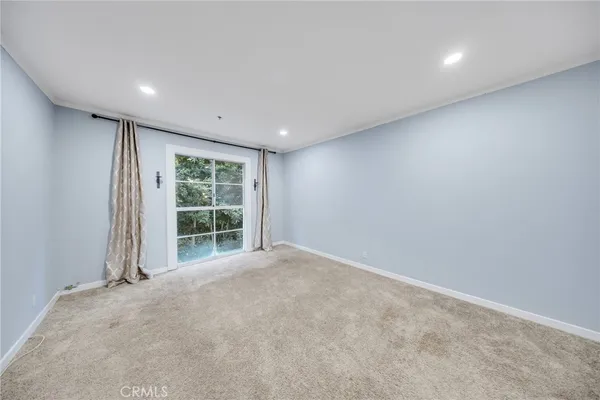 a view of wooden floor and windows in a room