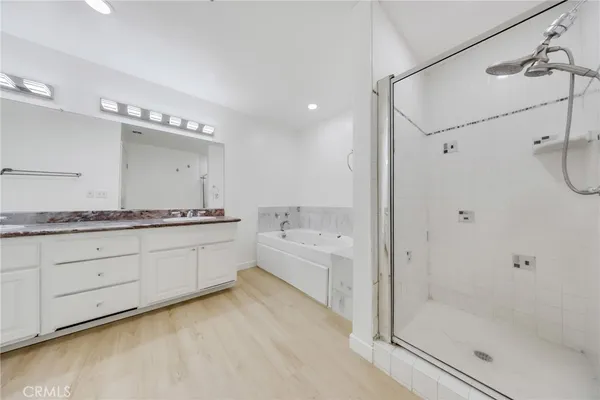 a bathroom with a shower sink vanity mirror and toilet