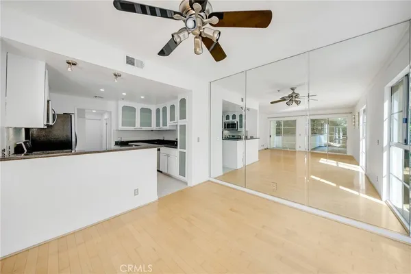 a view of kitchen with refrigerator and microwave