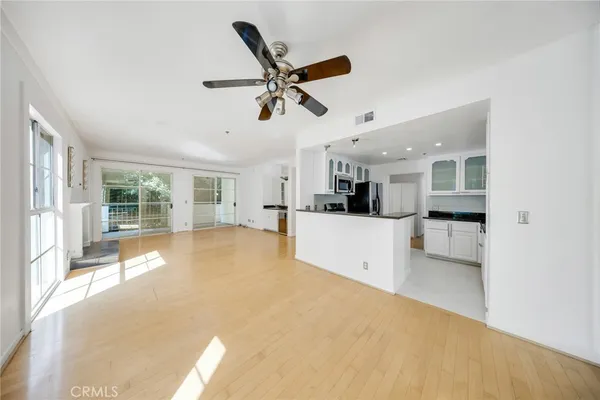 a view of a kitchen with furniture and a ceiling fan