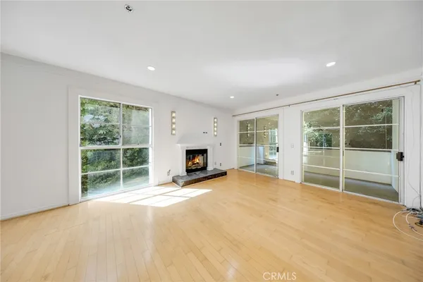 a view of an empty room with a window and a fireplace