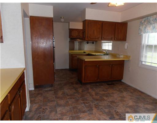 18 Edgewood Road Old Bridge, NJ 07747 - Photo 7 of 21 a kitchen with stainless steel appliances granite countertop a stove a refrigerator and a sink