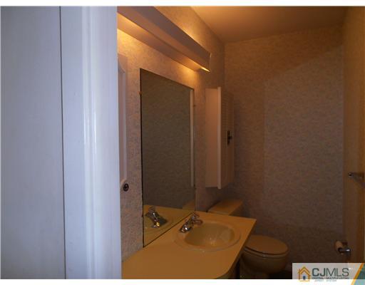 18 Edgewood Road Old Bridge, NJ 07747 - Photo 10 of 21 a bathroom with a sink and a mirror