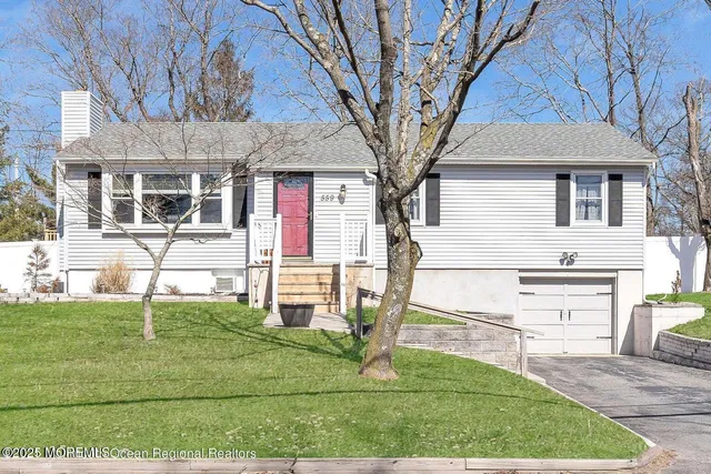 a view of a white house with a yard